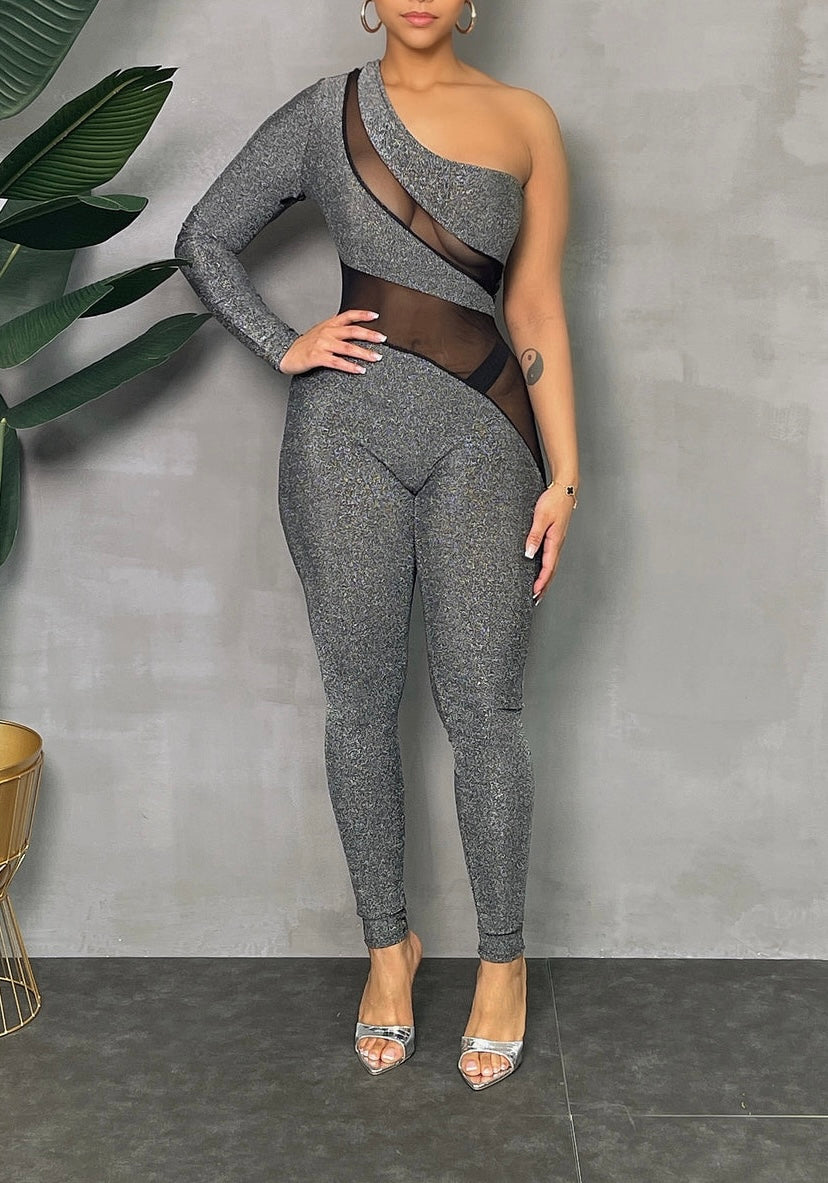 A gray one-shoulder lurex jumpsuit with a v-neckline and three-quarter sleeves, displayed against a neutral background.